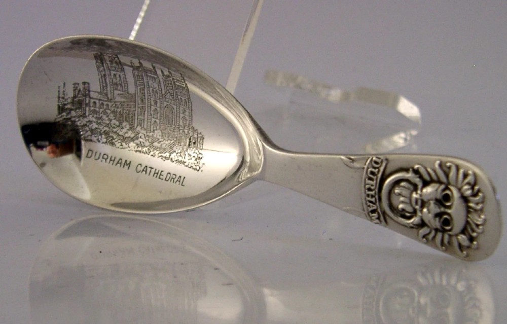 An Edwardian sterling silver tea caddy spoon featuring an engraved illustration of Durham Cathedral in the bowl and the Sanctuary Knocker on the handle. View IV