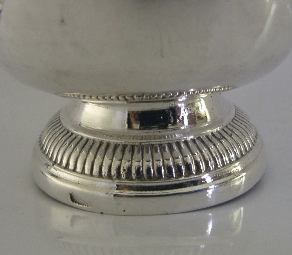 An 18th-century French sterling silver beaker cup featuring a flared rim, engraved lettering along the upper body, and a ribbed circular foot. View IV