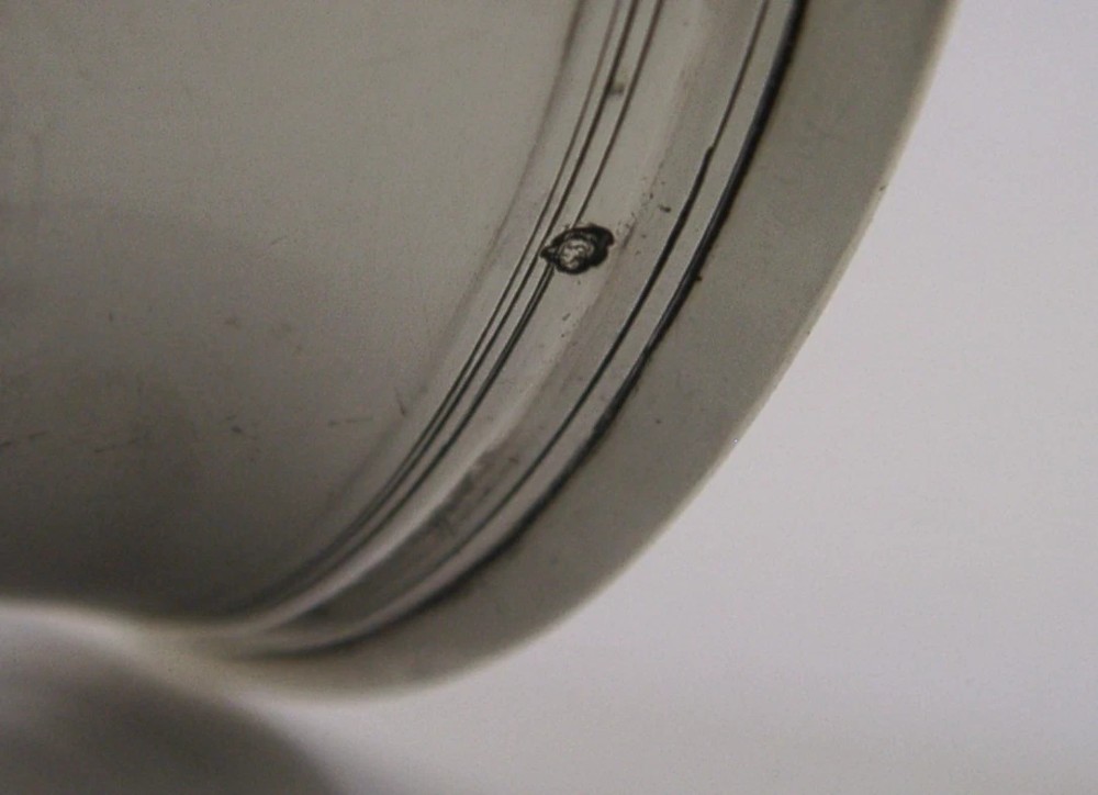 An 18th-century French sterling silver beaker cup featuring a flared rim, engraved lettering along the upper body, and a ribbed circular foot. View VII