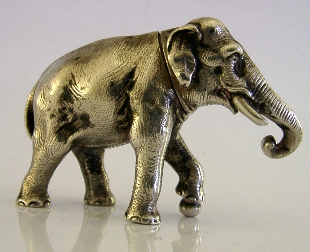 A detailed solid silver pounce box sculpted in the realistic shape of an elephant with a curved trunk. View IV