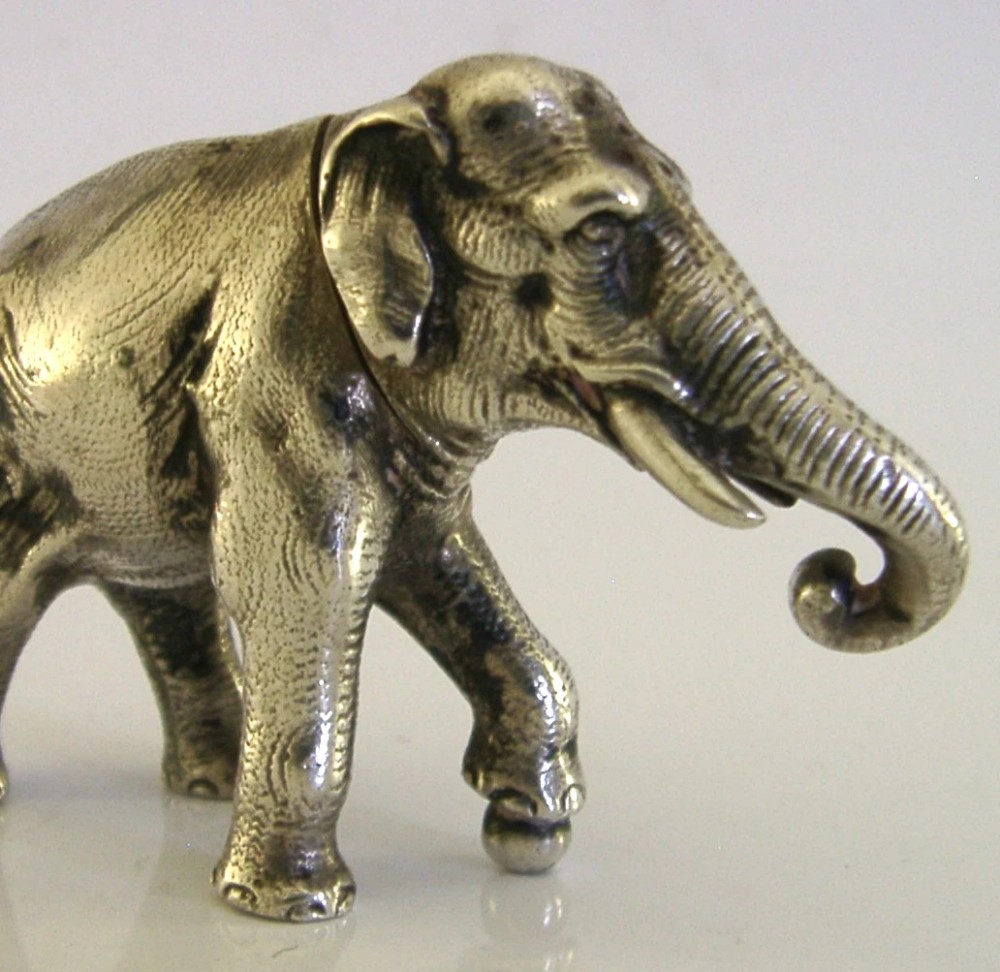 A detailed solid silver pounce box sculpted in the realistic shape of an elephant with a curved trunk. View VI