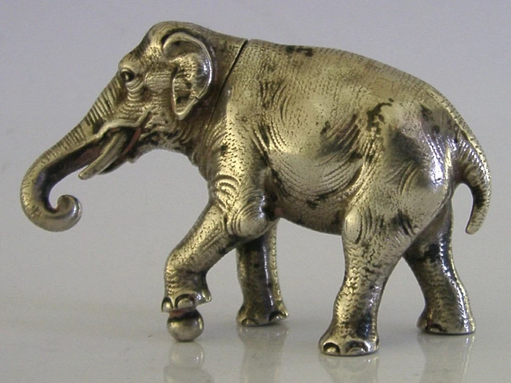 A detailed solid silver pounce box sculpted in the realistic shape of an elephant with a curved trunk. View VIII