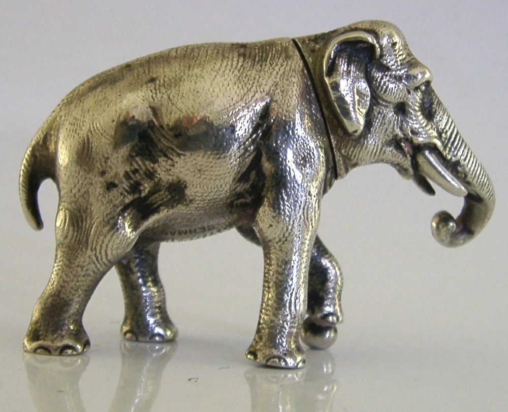 A detailed solid silver pounce box sculpted in the realistic shape of an elephant with a curved trunk. View IX