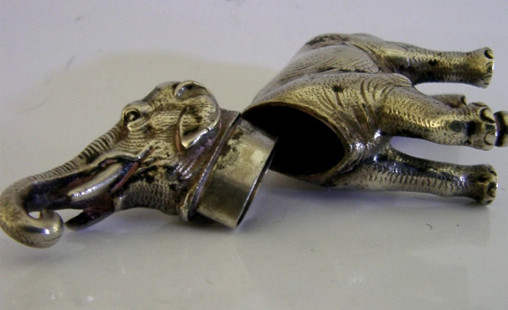 A detailed solid silver pounce box sculpted in the realistic shape of an elephant with a curved trunk. View X