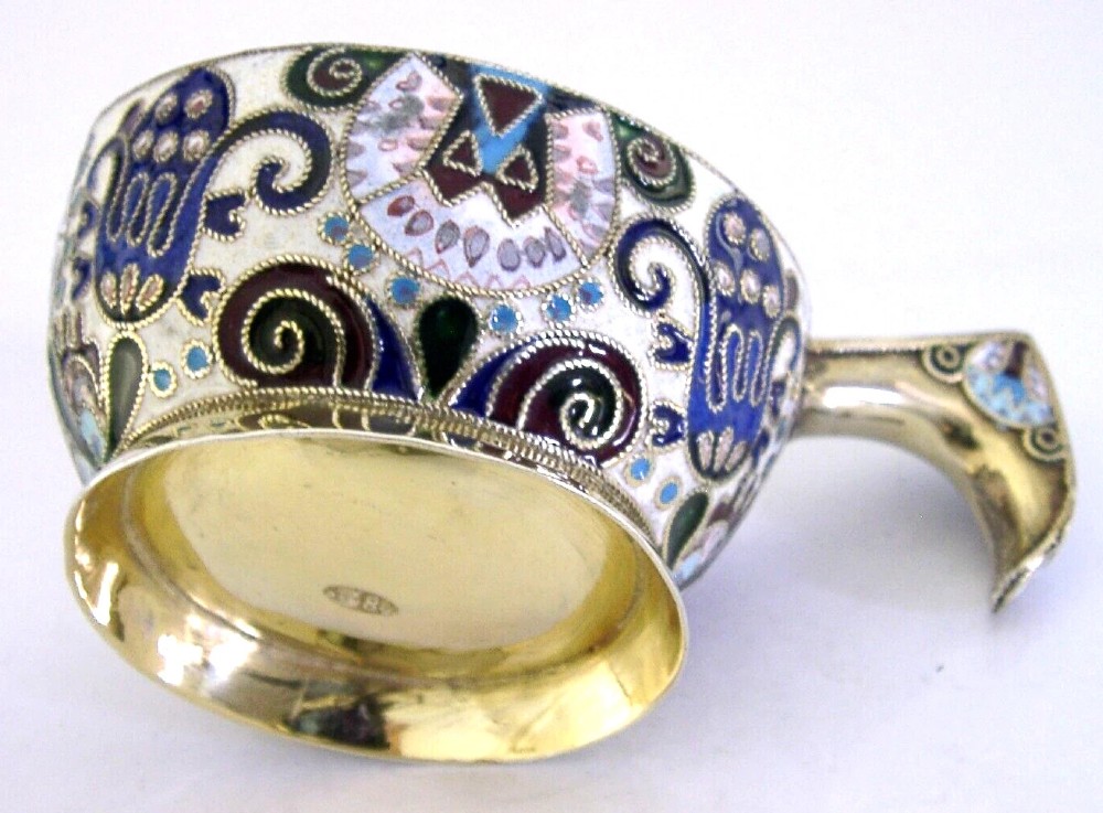 An antique boat-shaped Russian silver-gilt kovsh decorated with polychrome cloisonne enamel floral scrollwork and a gold-plated interior. View II