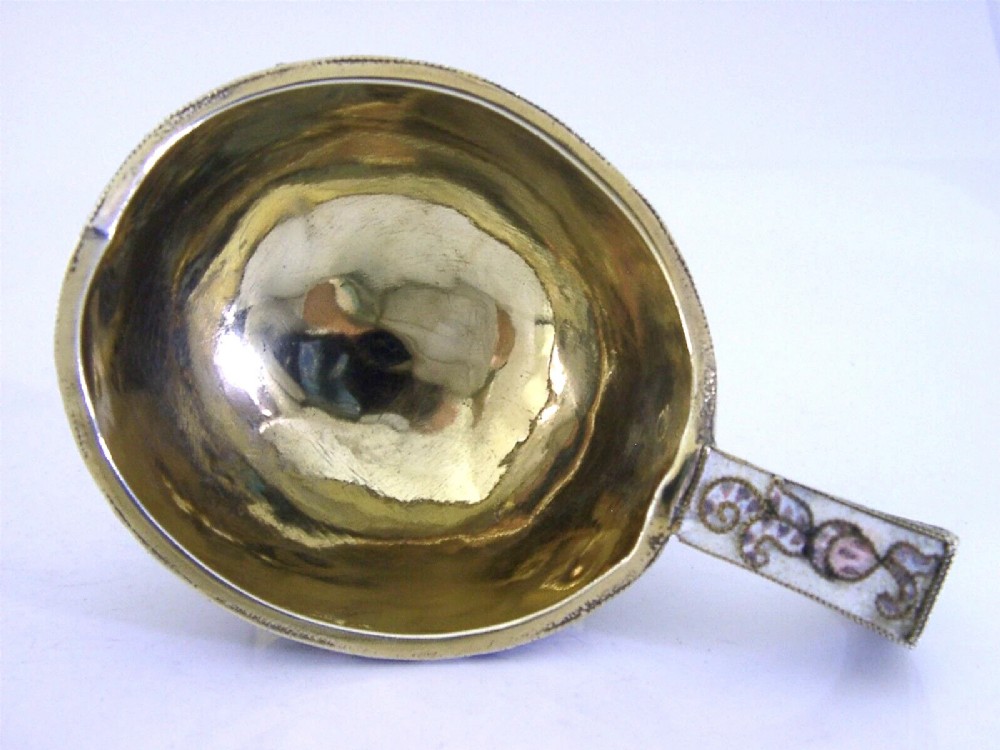 An antique boat-shaped Russian silver-gilt kovsh decorated with polychrome cloisonne enamel floral scrollwork and a gold-plated interior. View IX