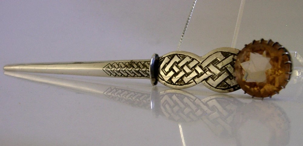 A Scottish sterling silver letter opener featuring Celtic interlace carving and an amber-toned citrine gem on the handle. View III
