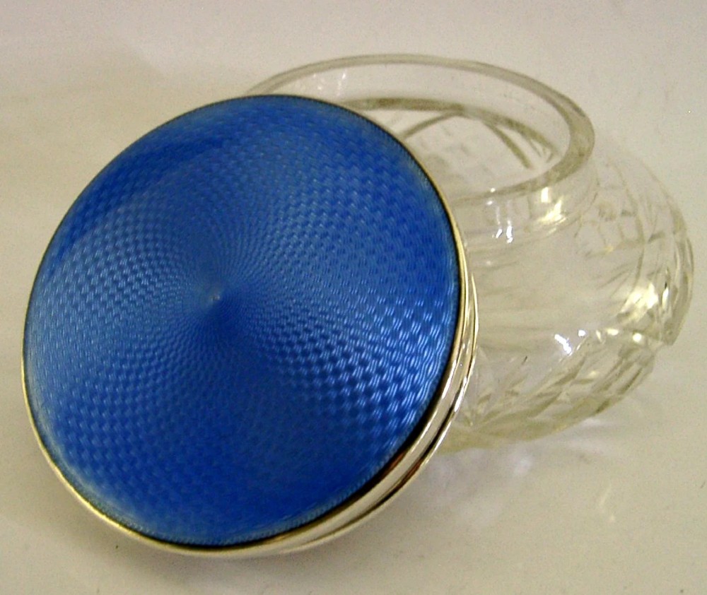 An Art Deco cut glass vanity jar featuring a sterling silver lid with royal blue engine-turned guilloche enamel. View II