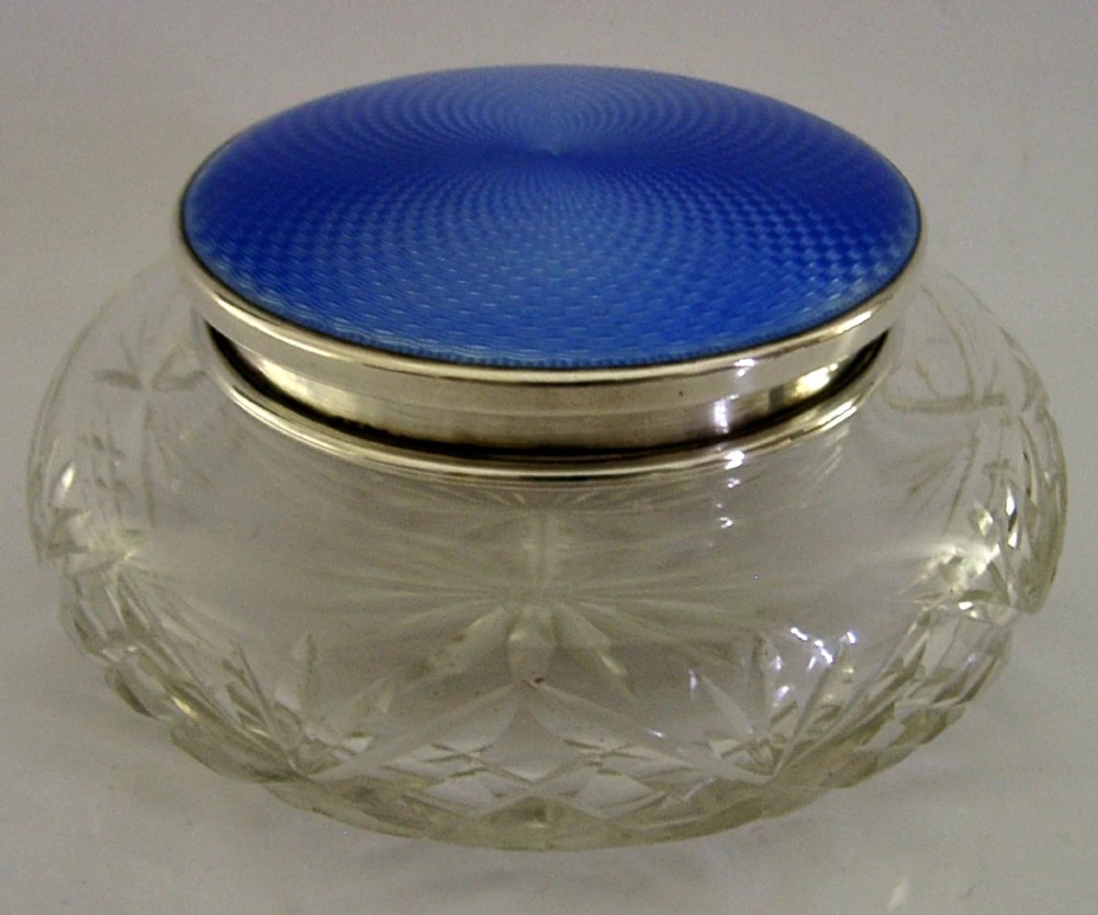 An Art Deco cut glass vanity jar featuring a sterling silver lid with royal blue engine-turned guilloche enamel. View III