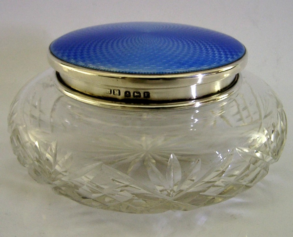 An Art Deco cut glass vanity jar featuring a sterling silver lid with royal blue engine-turned guilloche enamel. View IV