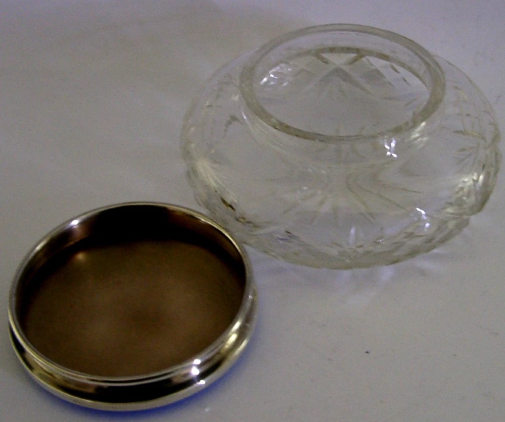 An Art Deco cut glass vanity jar featuring a sterling silver lid with royal blue engine-turned guilloche enamel. View VI