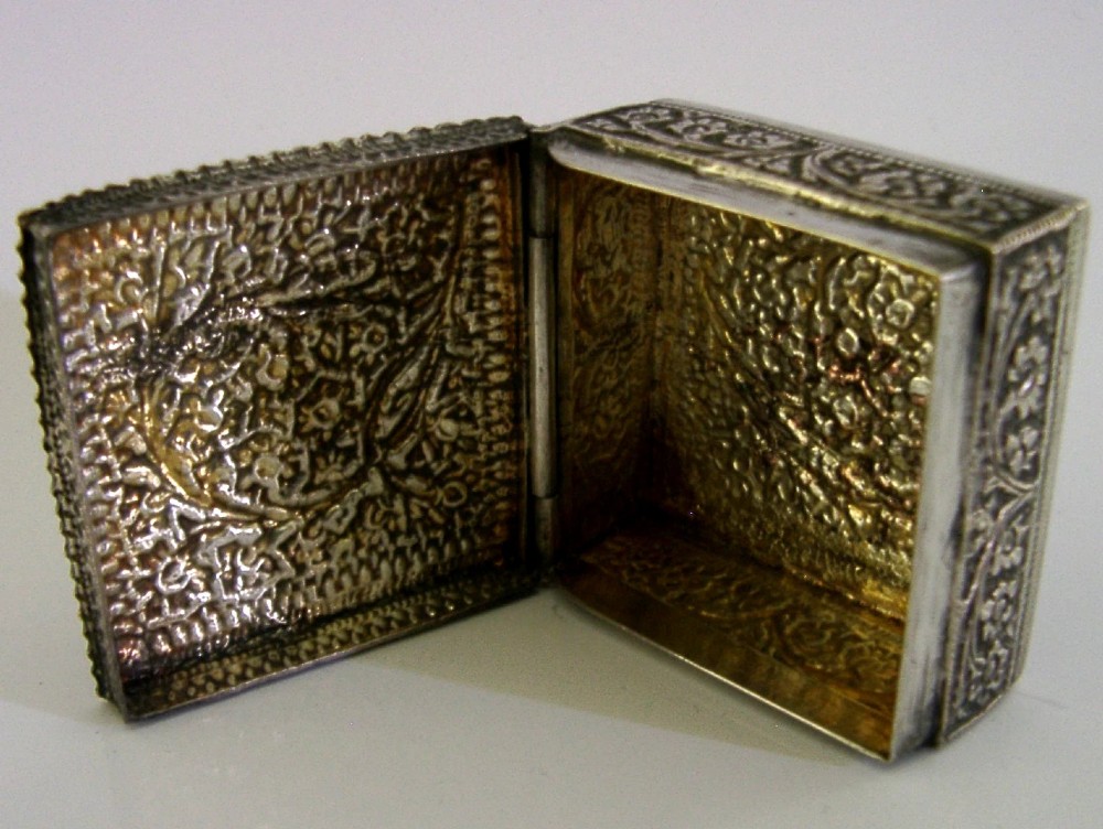 An open square solid silver box featuring detailed floral scroll repousse work across its exterior surface. View VI