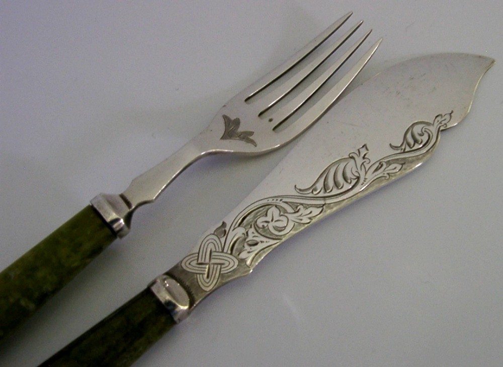 An antique silver-plated fish knife and fork set featuring engraved Celtic knotwork and smooth green marble handles. View II