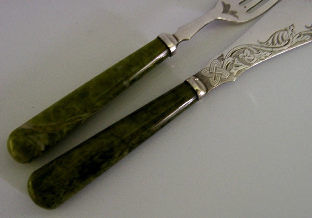 An antique silver-plated fish knife and fork set featuring engraved Celtic knotwork and smooth green marble handles. View III