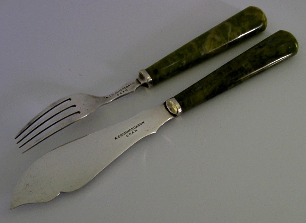 An antique silver-plated fish knife and fork set featuring engraved Celtic knotwork and smooth green marble handles. View IV
