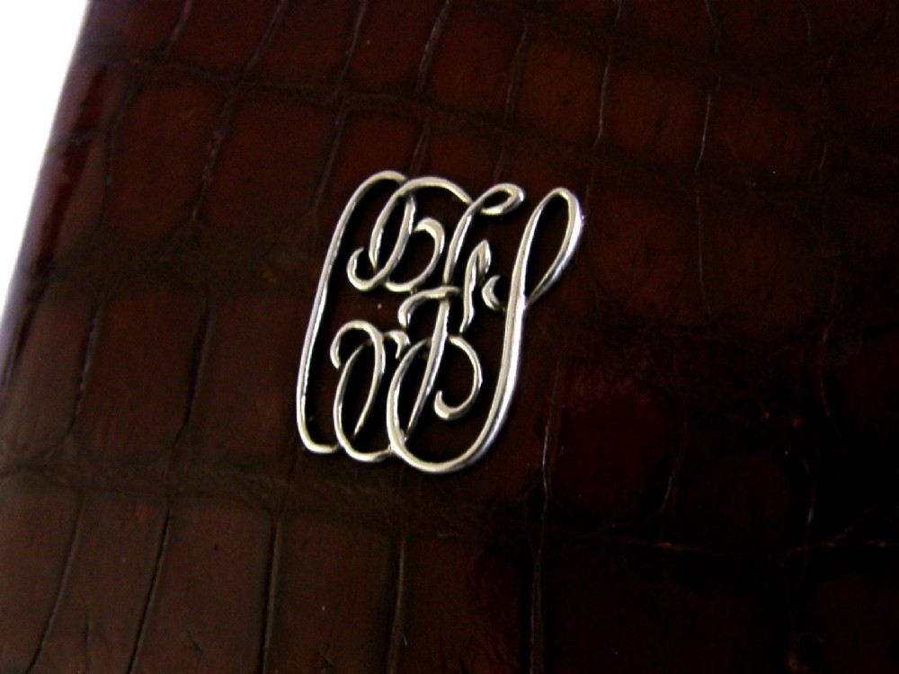 An Edwardian reddish-brown crocodile leather cigar case featuring a sterling silver hallmarked band at the top and an applied silver monogram on the front. View III