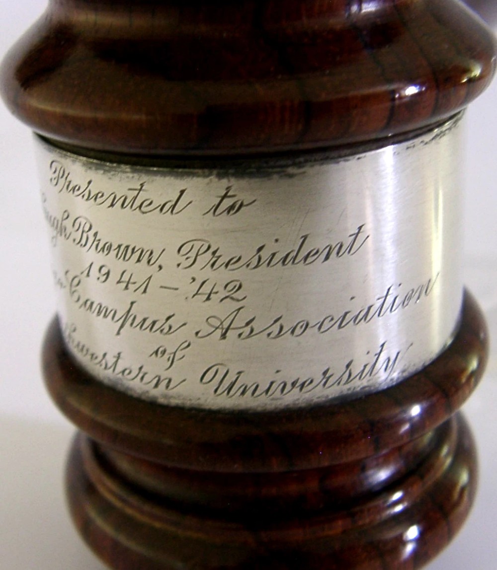 A turned dark hardwood gavel featuring a central sterling silver collar with engraved presentation text. View III