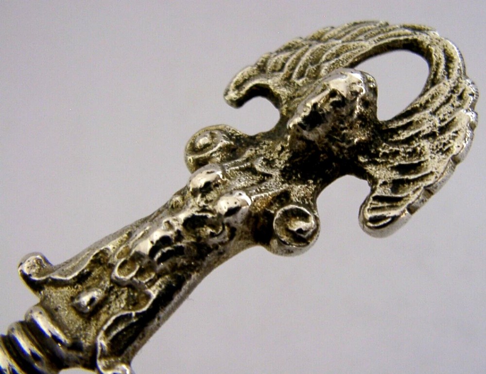 An antique Norwegian 830 silver baptism spoon featuring an engraved drop-shaped bowl and a detailed cast decorative handle. View II