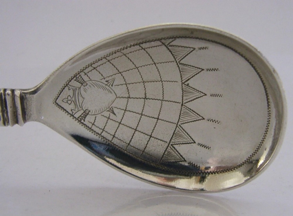 An antique Norwegian 830 silver baptism spoon featuring an engraved drop-shaped bowl and a detailed cast decorative handle. View III