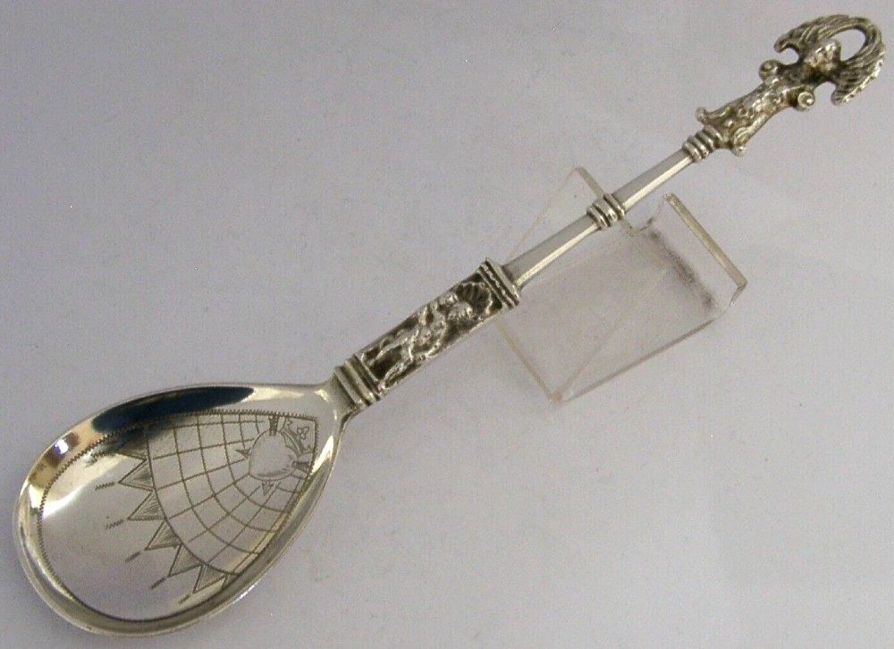 An antique Norwegian 830 silver baptism spoon featuring an engraved drop-shaped bowl and a detailed cast decorative handle. View IV