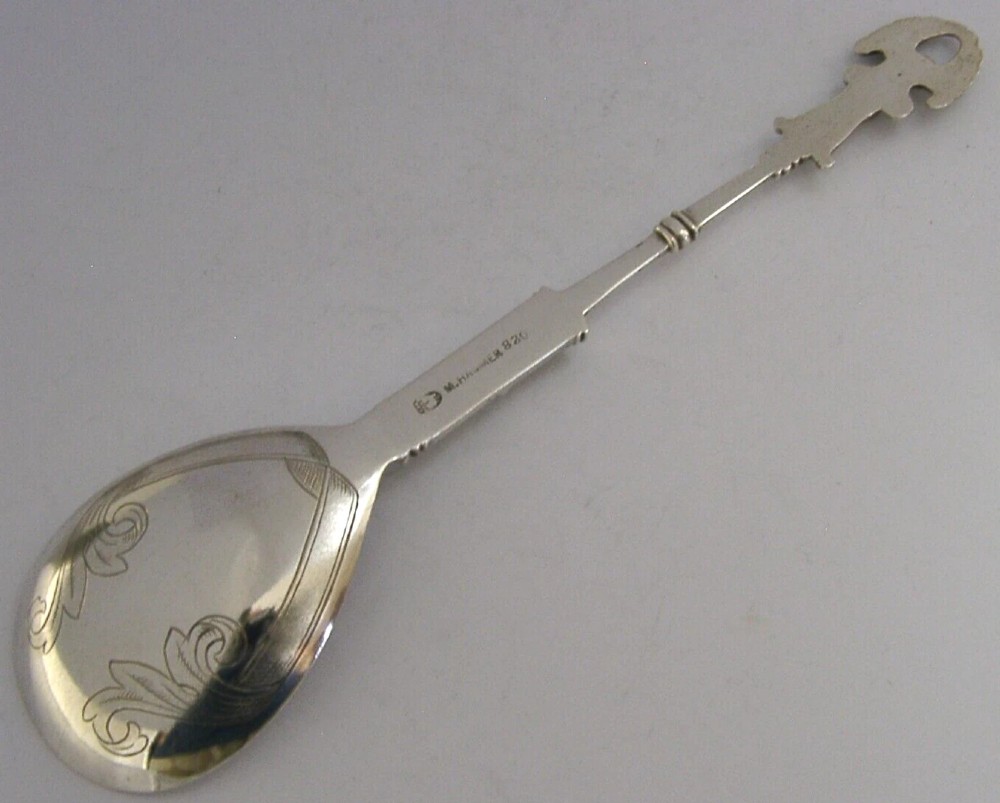 An antique Norwegian 830 silver baptism spoon featuring an engraved drop-shaped bowl and a detailed cast decorative handle. View V
