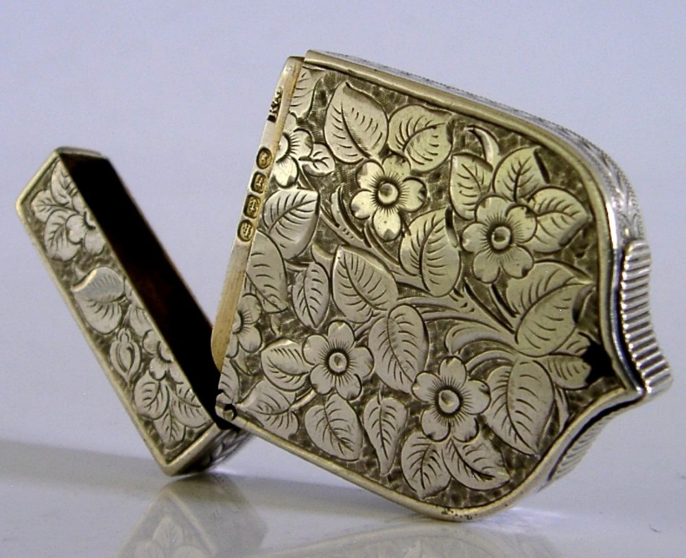 A Victorian shield-shaped sterling silver vesta case engraved with floral motifs and a central vacant cartouche. View III