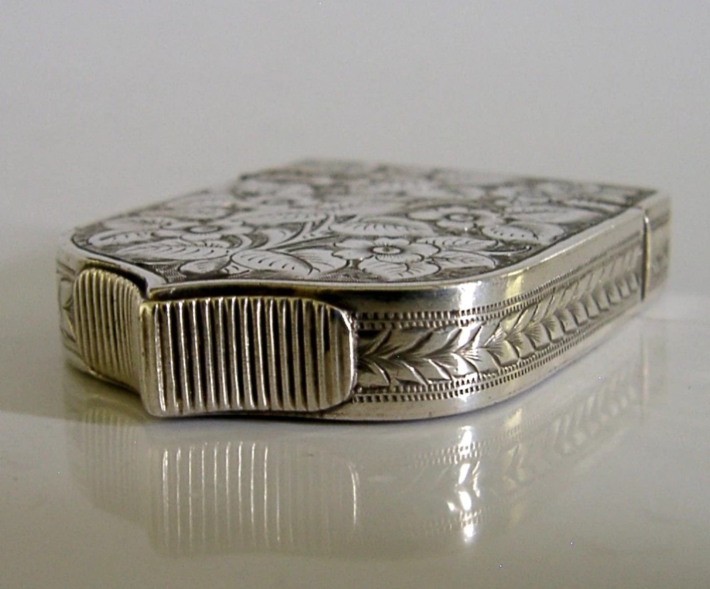 A Victorian shield-shaped sterling silver vesta case engraved with floral motifs and a central vacant cartouche. View IV