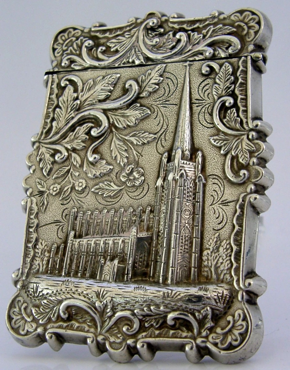 A mid-19th-century sterling silver card case featuring an embossed architectural depiction of Trinity Church surrounded by foliate scrollwork. View III