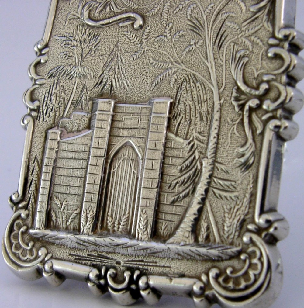 A mid-19th-century sterling silver card case featuring an embossed architectural depiction of Trinity Church surrounded by foliate scrollwork. View VII