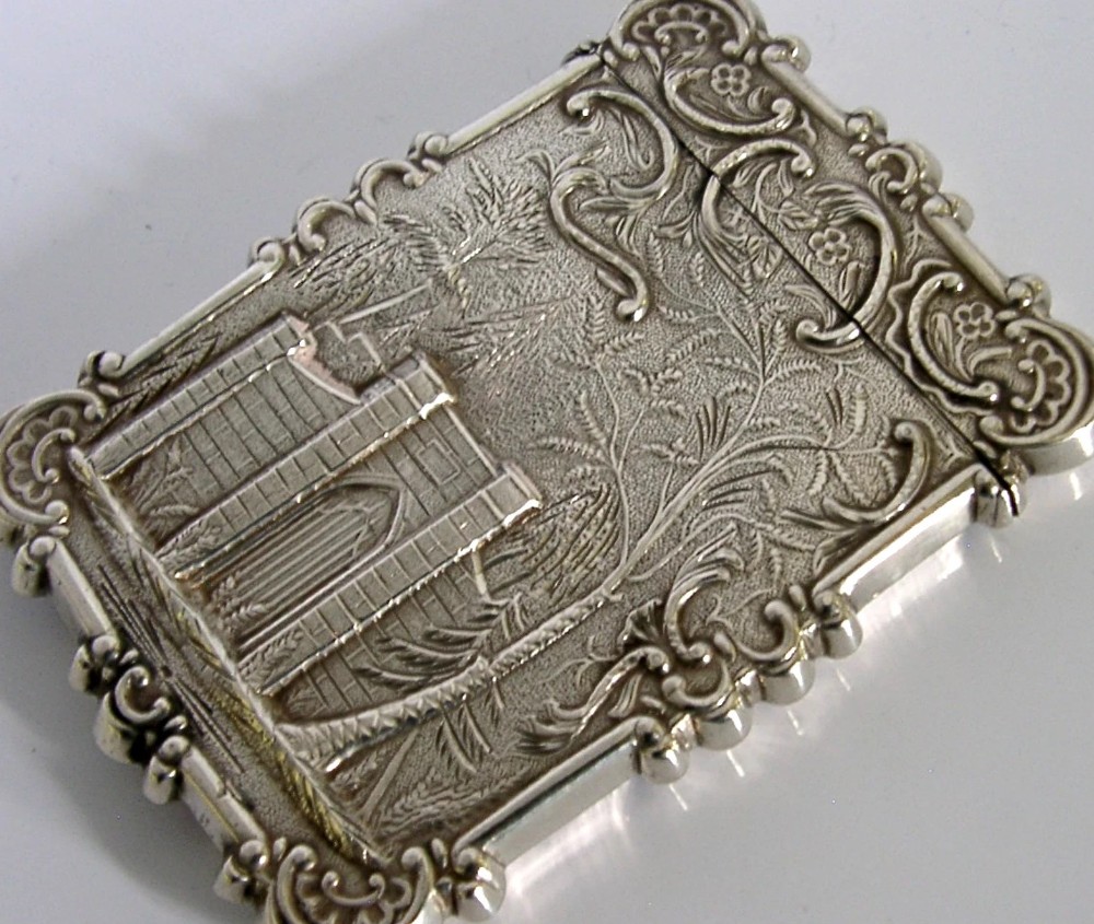 A mid-19th-century sterling silver card case featuring an embossed architectural depiction of Trinity Church surrounded by foliate scrollwork. View X