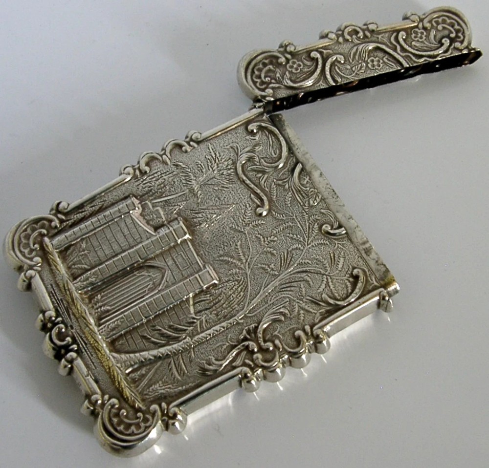 A mid-19th-century sterling silver card case featuring an embossed architectural depiction of Trinity Church surrounded by foliate scrollwork. View XI