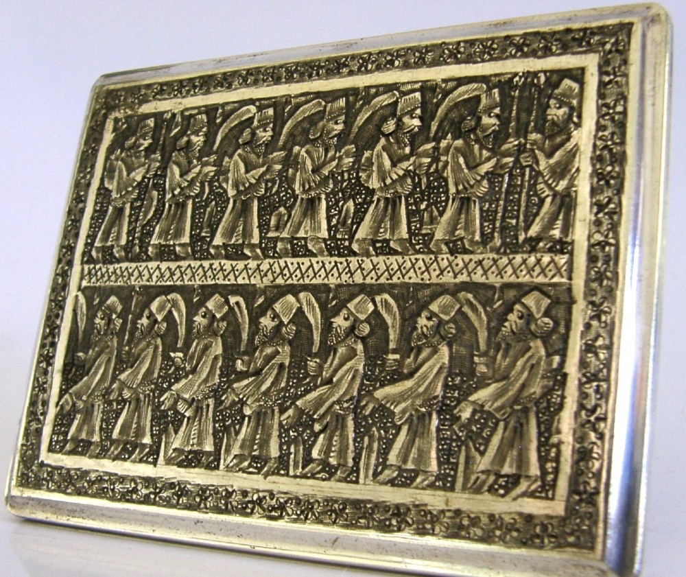 A rectangular solid silver cigarette case featuring hand-chased relief work depicting birds and floral motifs surrounded by a decorative border. View III