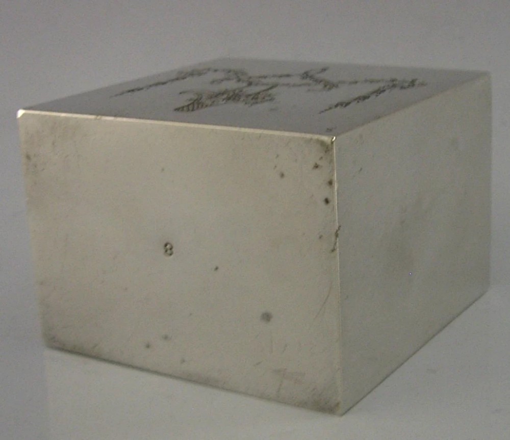 An antique Edwardian rectangular sterling silver tea caddy decorated with delicate engraved floral swags and a central flower basket, topped with a square cap lid. View IX