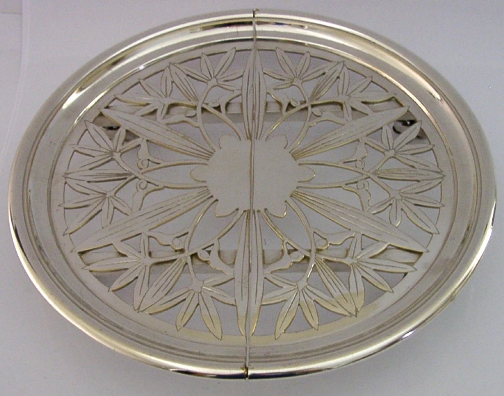 A circular French Art Deco silver plated extending dish stand featuring pierced botanical foliage motifs. View V