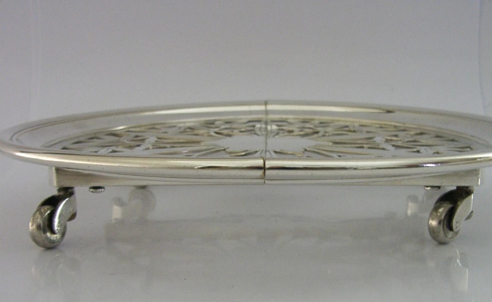 A circular French Art Deco silver plated extending dish stand featuring pierced botanical foliage motifs. View VI
