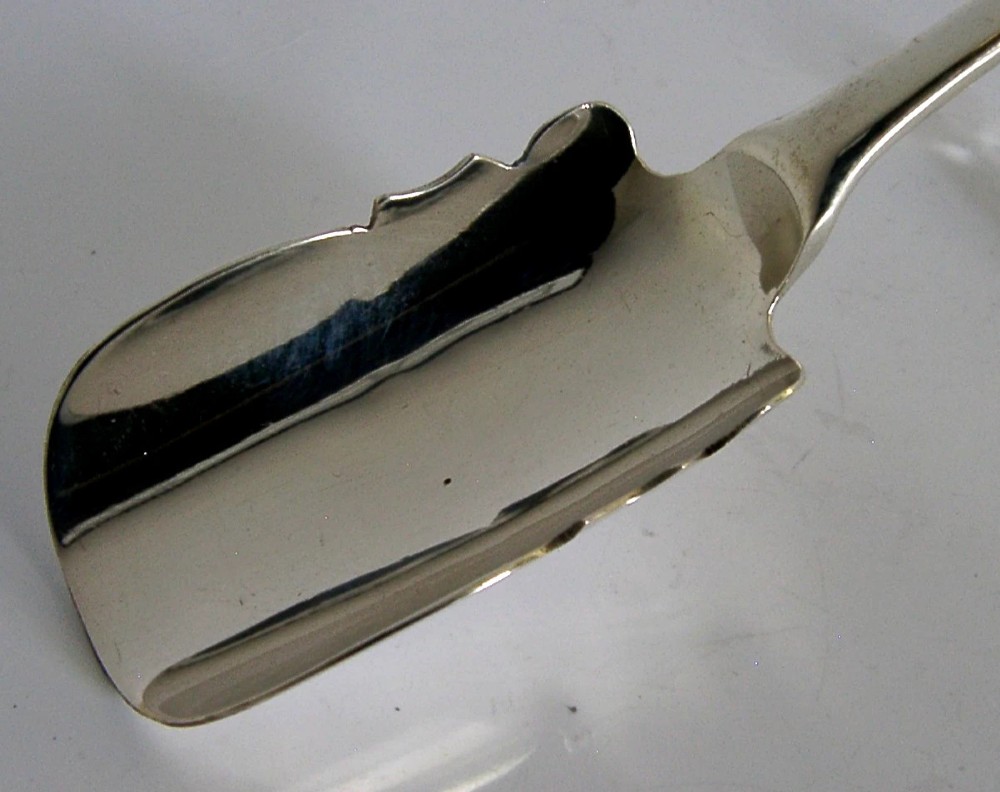 A solid sterling silver George III Stilton cheese scoop with a long tapered handle and a curved trough-shaped blade. View II