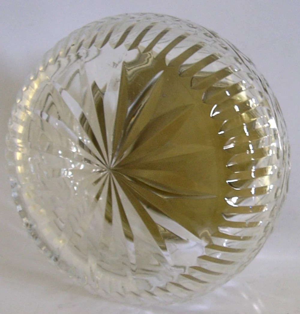 A circular cut glass vanity jar with a sterling silver rim and a bronze guilloche enamelled lid displaying a sunburst pattern. View VI