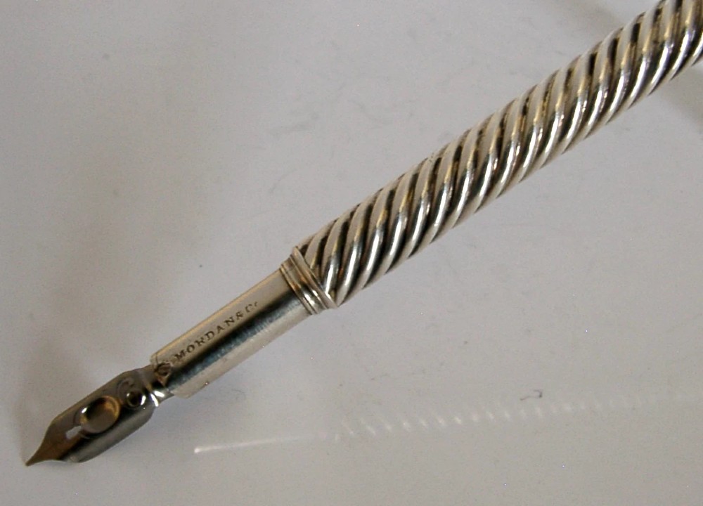 A Victorian sterling silver dip pen featuring a spiral fluted barrel and a metal writing nib. View II