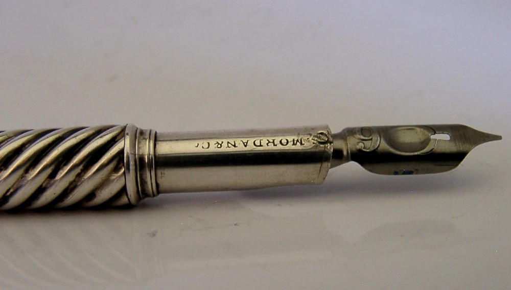 A Victorian sterling silver dip pen featuring a spiral fluted barrel and a metal writing nib. View III