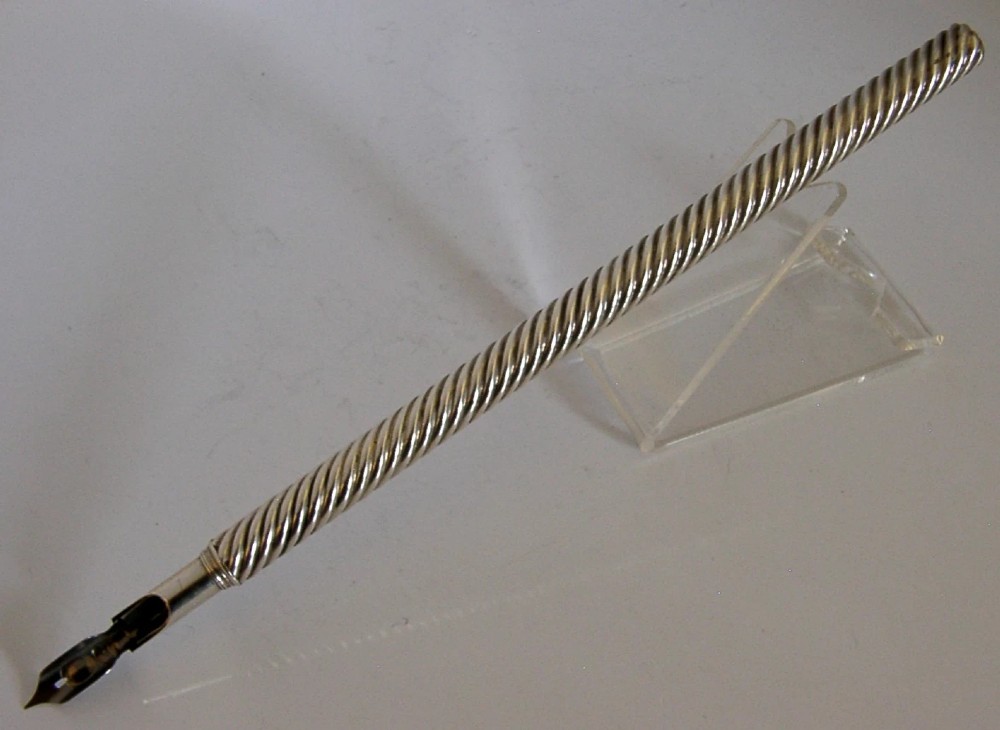 A Victorian sterling silver dip pen featuring a spiral fluted barrel and a metal writing nib. View VII