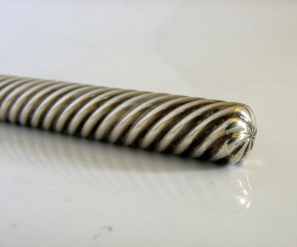 A Victorian sterling silver dip pen featuring a spiral fluted barrel and a metal writing nib. View VIII