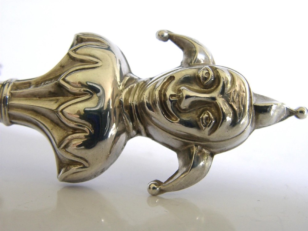 An Edwardian sterling silver sealing wax holder topped with a cast jester bust wearing a cap and bells. View II