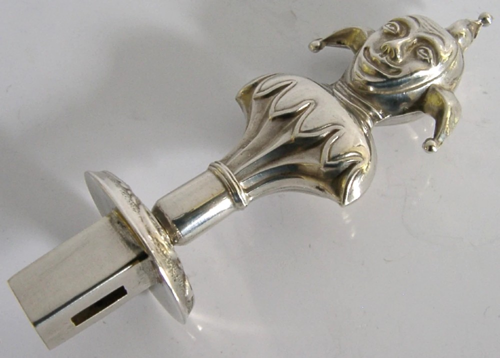 An Edwardian sterling silver sealing wax holder topped with a cast jester bust wearing a cap and bells. View IV
