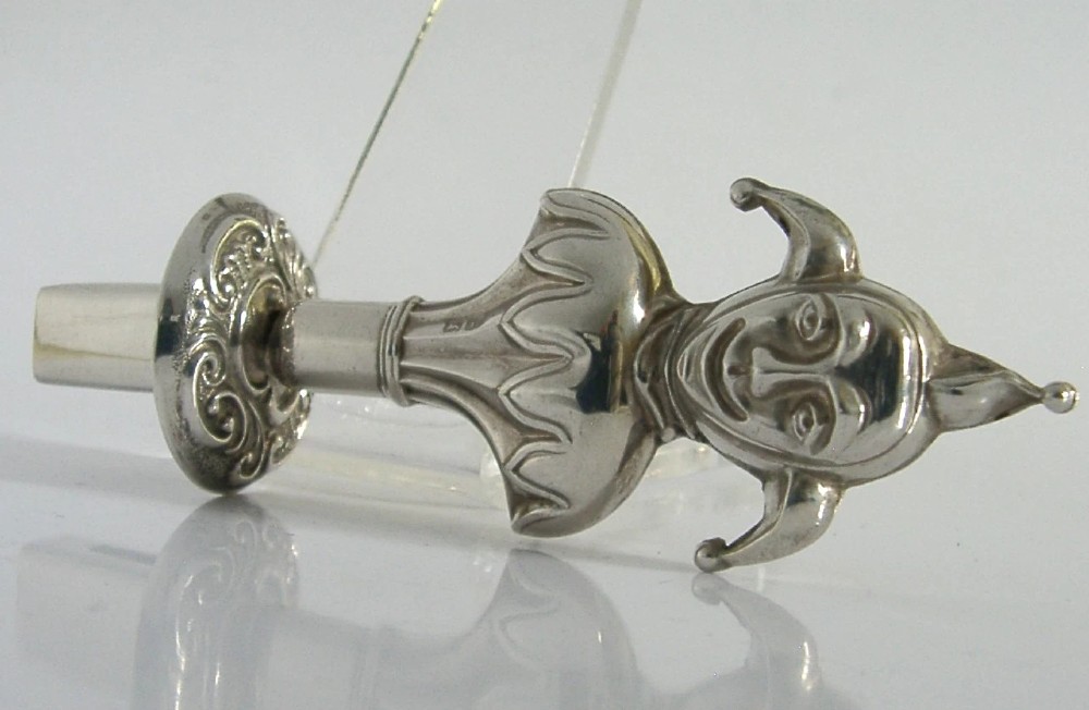 An Edwardian sterling silver sealing wax holder topped with a cast jester bust wearing a cap and bells. View VI