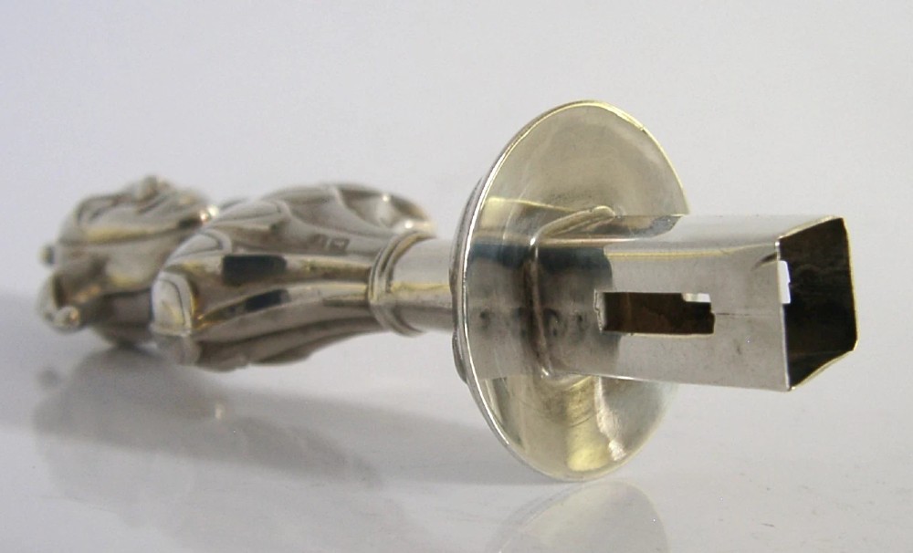 An Edwardian sterling silver sealing wax holder topped with a cast jester bust wearing a cap and bells. View VII