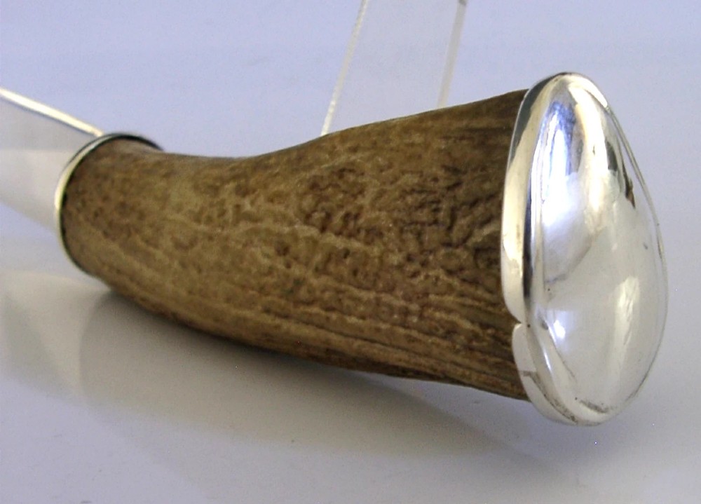 A Scottish provincial sterling silver page turner featuring a smooth silver blade mounted to a natural curved horn handle with a silver end cap. View VII