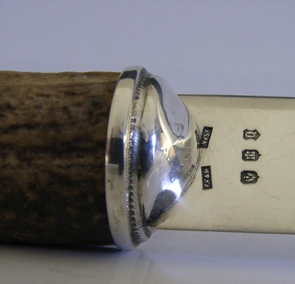 A Scottish provincial sterling silver page turner featuring a smooth silver blade mounted to a natural curved horn handle with a silver end cap. View X