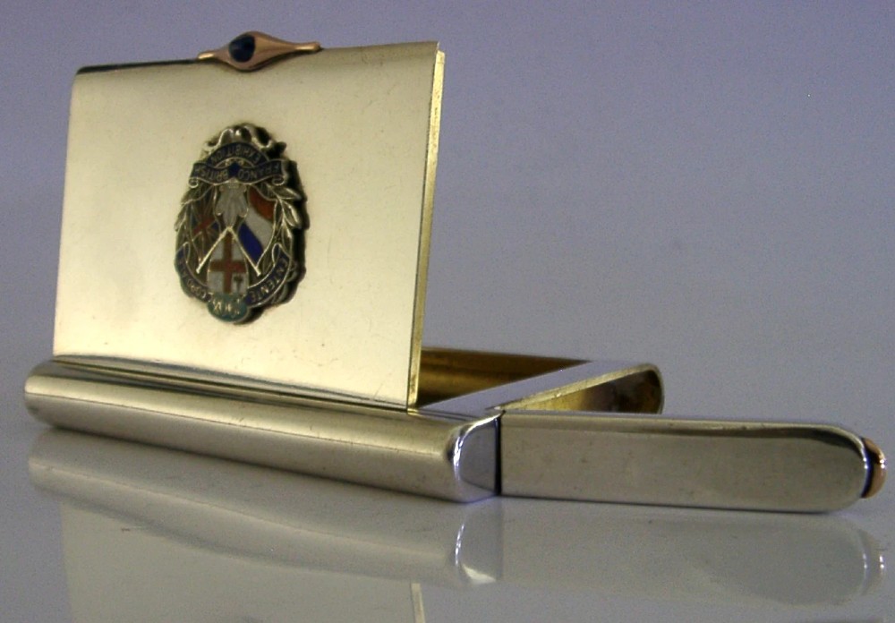 A rectangular silver cigarette case featuring a central enamel emblem depicting British and French flags with Entente Cordiale lettering and a gold thumbpiece. View II