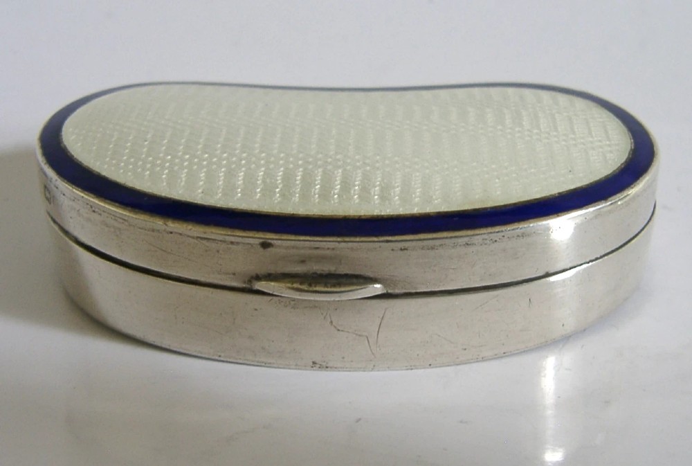 An Edwardian kidney-shaped sterling silver box featuring a white guilloche enamelled lid bordered with deep royal blue enamel. View V