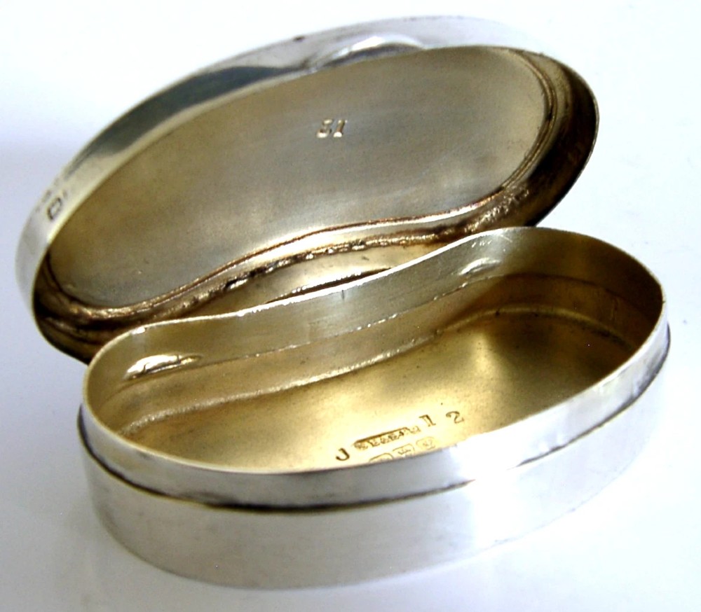 An Edwardian kidney-shaped sterling silver box featuring a white guilloche enamelled lid bordered with deep royal blue enamel. View VIII